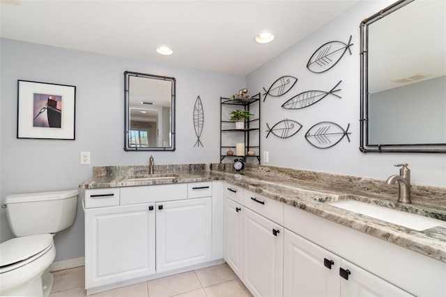 full bath featuring tile patterned floors, double vanity, toilet, and a sink