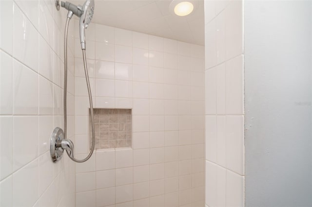 interior details with a tile shower