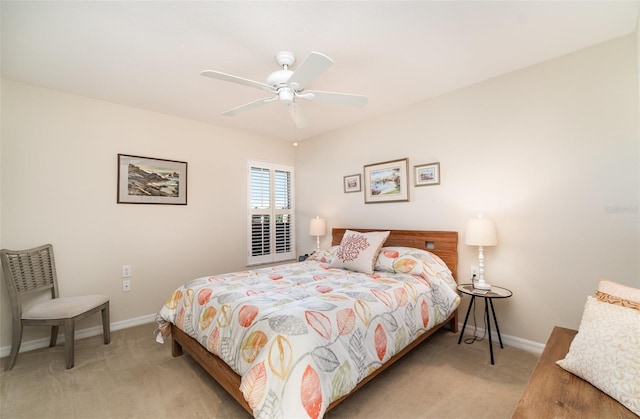 bedroom with a ceiling fan, light colored carpet, and baseboards