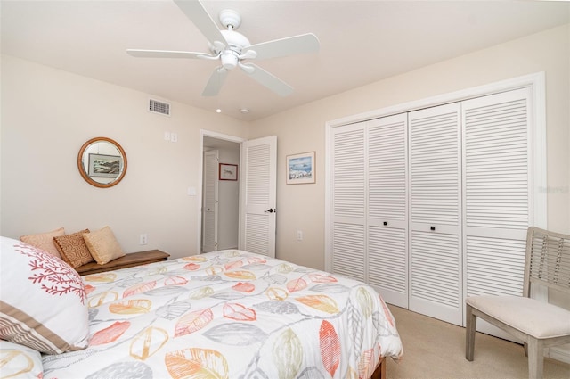 bedroom featuring visible vents, light colored carpet, a closet, and a ceiling fan