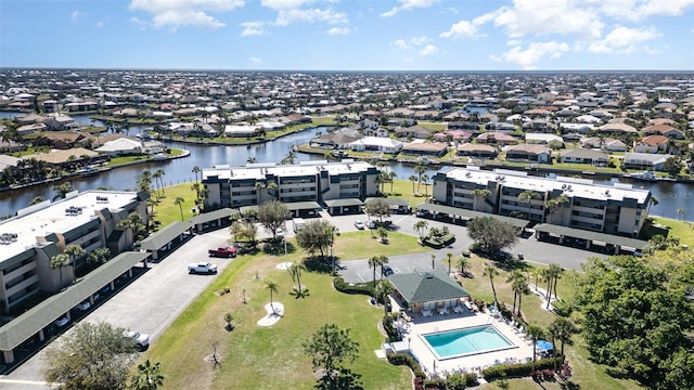 birds eye view of property with a water view and a residential view