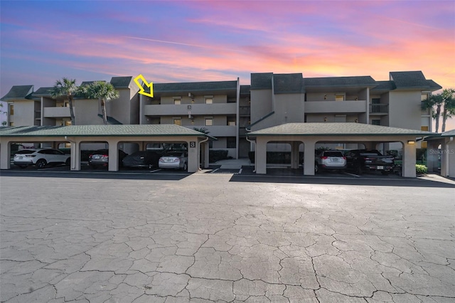 property at dusk with covered parking