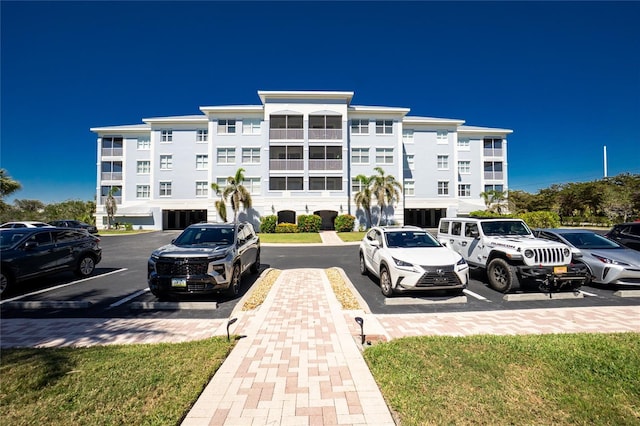 view of building exterior with uncovered parking