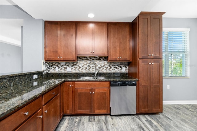 kitchen with a sink, decorative backsplash, light wood-type flooring, and dishwasher