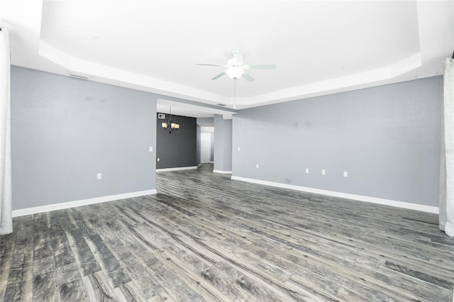 unfurnished room with a ceiling fan, wood finished floors, baseboards, visible vents, and a raised ceiling