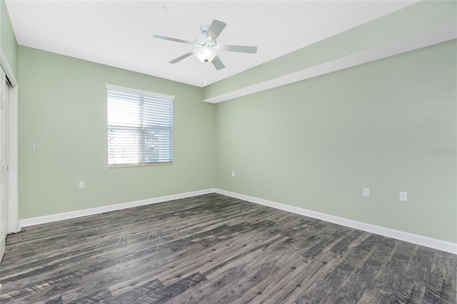 unfurnished room with dark wood finished floors, baseboards, and ceiling fan