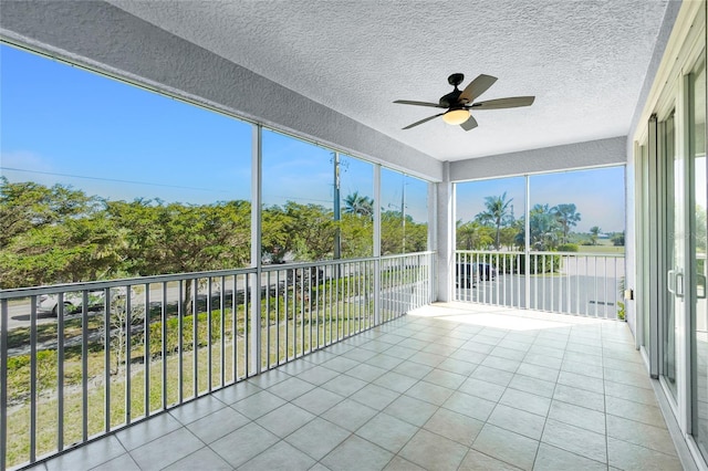 unfurnished sunroom featuring a ceiling fan