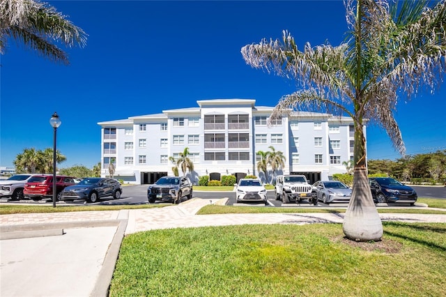 view of building exterior featuring uncovered parking