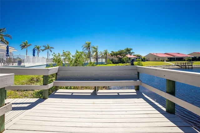 dock area with a deck and a residential view