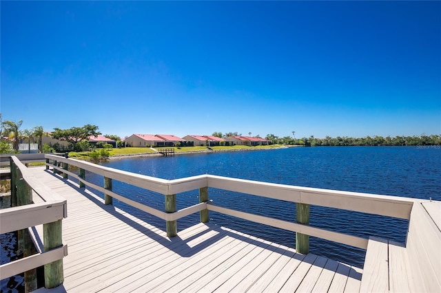 view of dock with a water view and a residential view