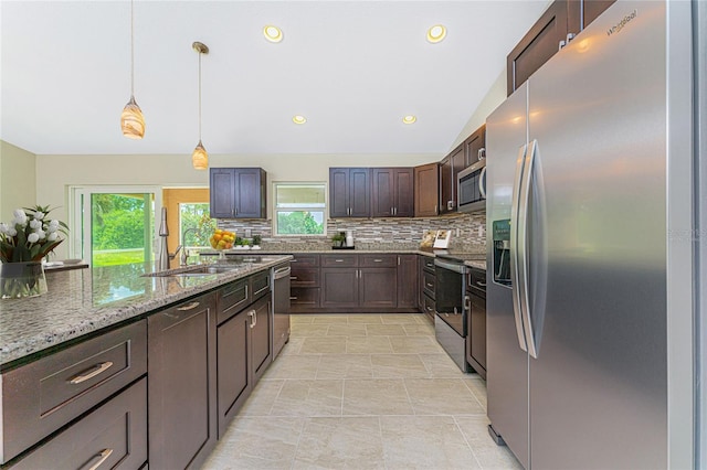 kitchen with tasteful backsplash, dark brown cabinets, vaulted ceiling, appliances with stainless steel finishes, and a sink