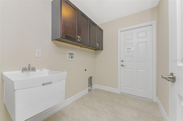 laundry room featuring electric dryer hookup, baseboards, cabinet space, and hookup for a washing machine