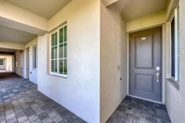 entrance to property featuring stucco siding