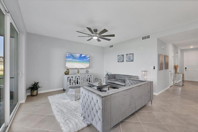 living area with light tile patterned floors, visible vents, and baseboards