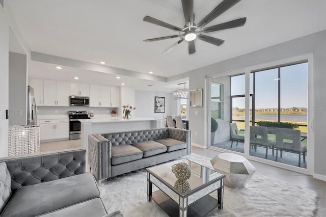 living room featuring light tile patterned floors, recessed lighting, baseboards, and ceiling fan