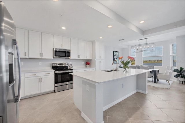 kitchen featuring a sink, white cabinetry, appliances with stainless steel finishes, light tile patterned flooring, and light countertops