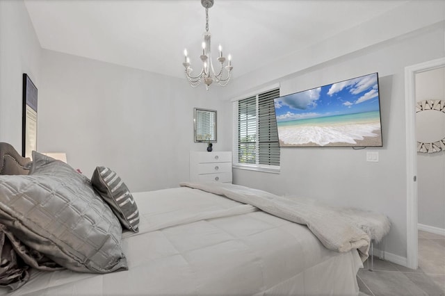 tiled bedroom featuring baseboards and a notable chandelier