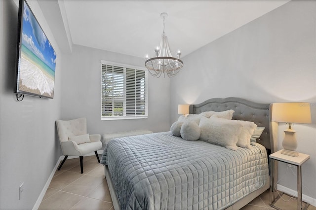 bedroom featuring tile patterned floors, baseboards, and an inviting chandelier