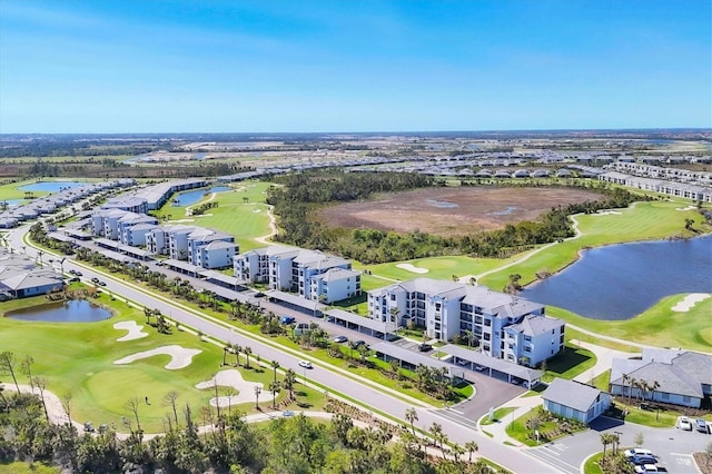 aerial view with a water view and view of golf course