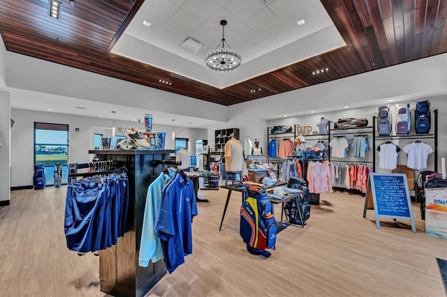 misc room featuring wood finished floors, visible vents, an inviting chandelier, wood ceiling, and a raised ceiling