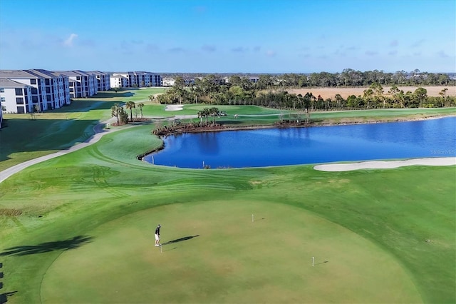 view of community featuring golf course view and a water view