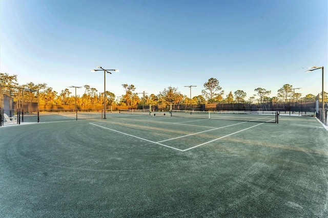 view of sport court featuring fence