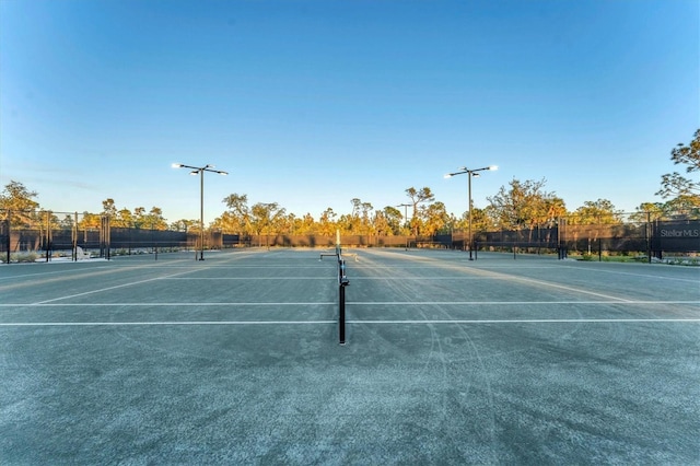 view of tennis court with fence