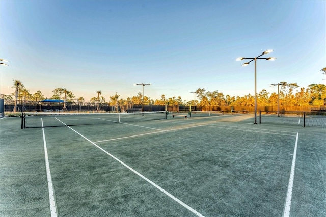 view of tennis court with fence