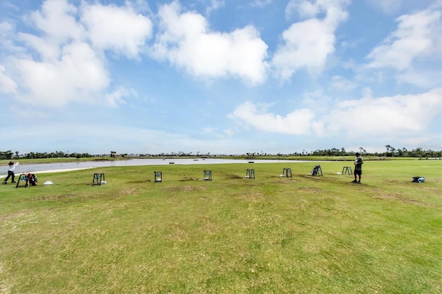 view of community with a water view and a lawn