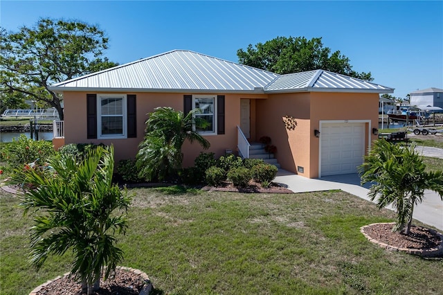 ranch-style house featuring a front yard, driveway, stucco siding, a water view, and a garage