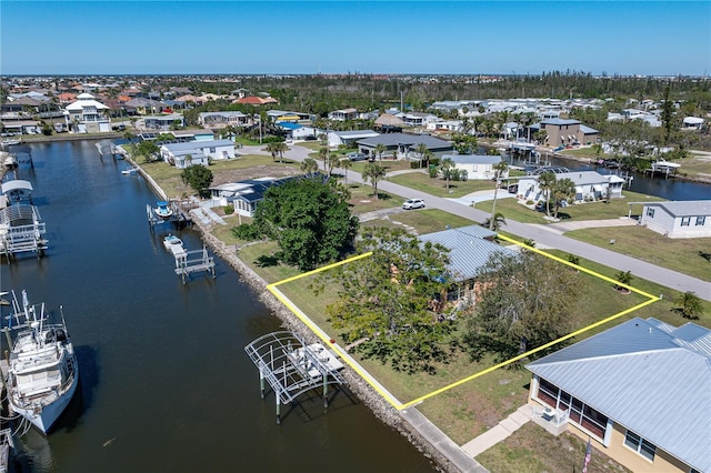 drone / aerial view with a residential view and a water view