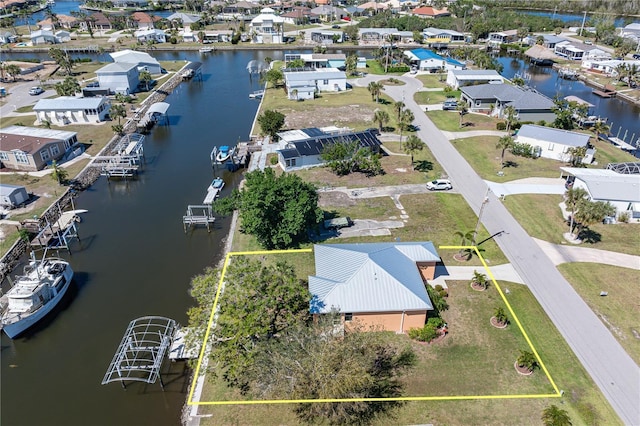 drone / aerial view featuring a residential view and a water view