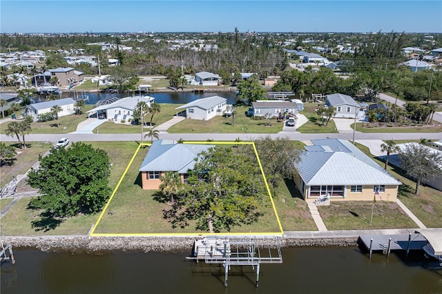 birds eye view of property featuring a residential view and a water view