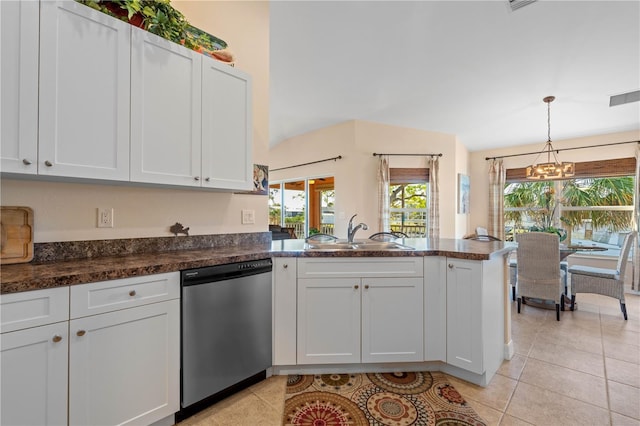 kitchen with a notable chandelier, a sink, stainless steel dishwasher, a peninsula, and light tile patterned floors