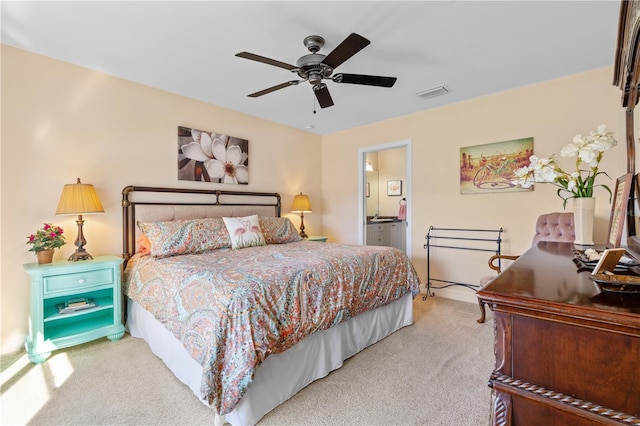 bedroom featuring ensuite bath, carpet flooring, a ceiling fan, and visible vents