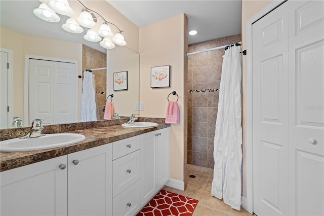 full bathroom with a tile shower and a sink