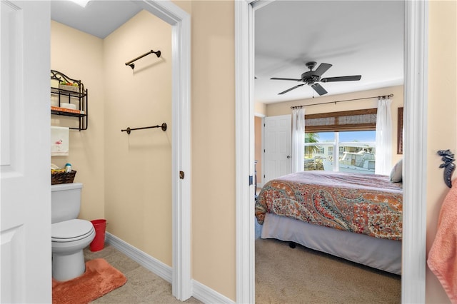 ensuite bathroom with toilet, a ceiling fan, baseboards, and ensuite bathroom