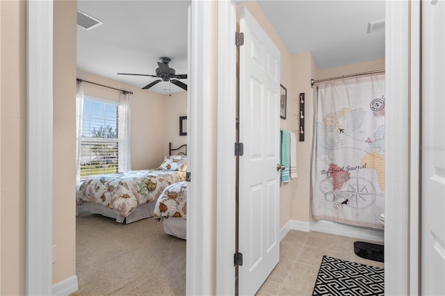 ensuite bathroom featuring visible vents, a shower with shower curtain, ensuite bathroom, tile patterned floors, and a ceiling fan