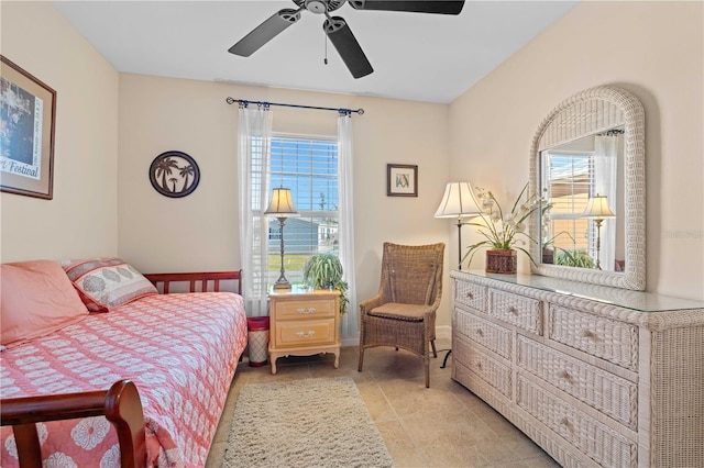 bedroom with multiple windows, light tile patterned floors, and ceiling fan