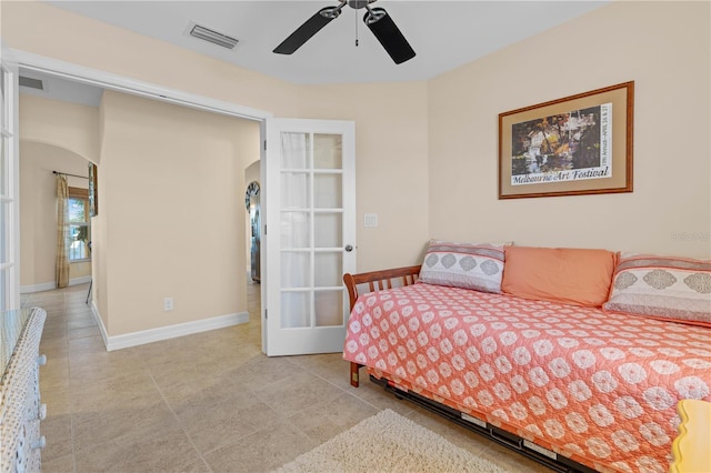 bedroom with visible vents, arched walkways, and baseboards