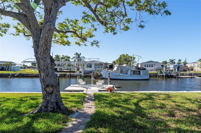 dock area featuring a yard, a water view, and a residential view