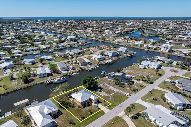 drone / aerial view with a residential view and a water view