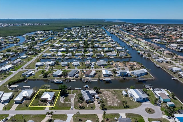 drone / aerial view featuring a residential view and a water view