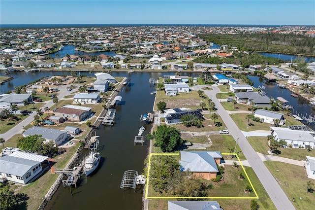 drone / aerial view featuring a residential view and a water view