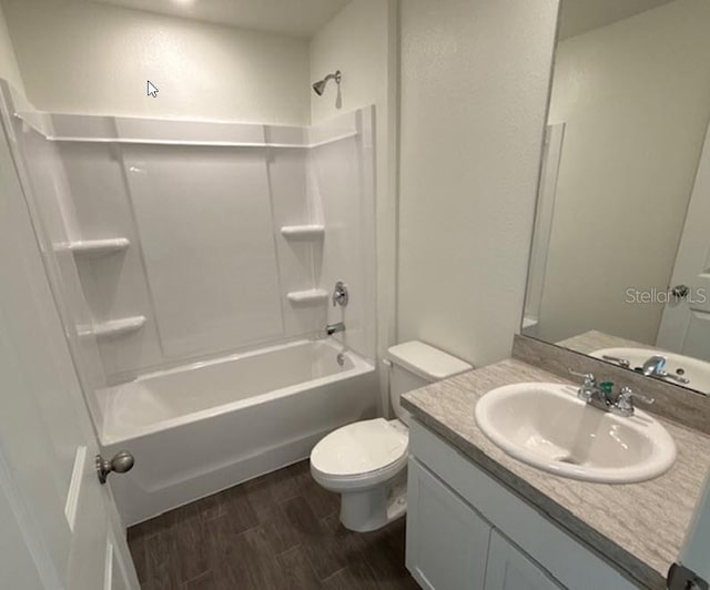 full bath featuring vanity, toilet, wood finished floors, and tub / shower combination