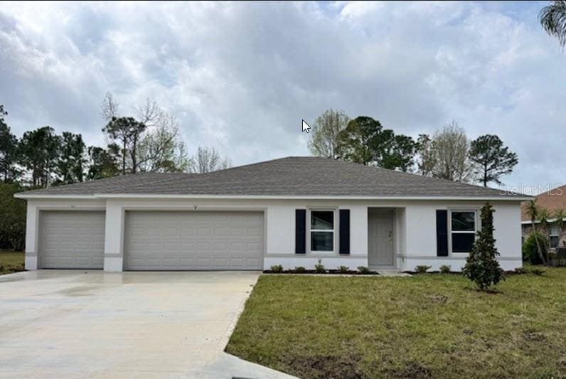 single story home with stucco siding, an attached garage, driveway, and a front lawn