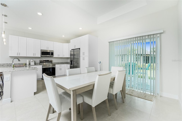 dining space featuring light tile patterned floors, recessed lighting, and baseboards