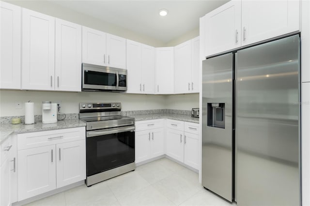 kitchen featuring light tile patterned floors, appliances with stainless steel finishes, white cabinets, and recessed lighting