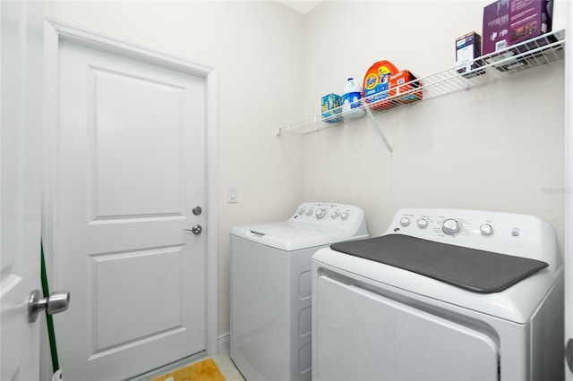 clothes washing area with laundry area and washer and clothes dryer