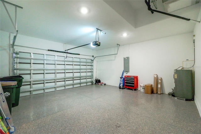 garage featuring water heater, a garage door opener, and electric panel